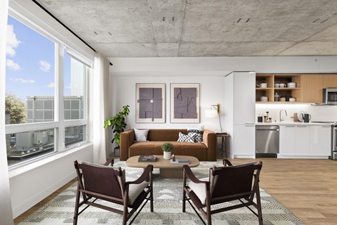 A modern living room with a brown couch and a coffee table.