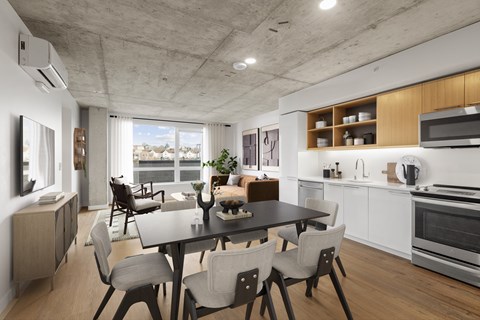 A modern kitchen with a dining table and chairs.