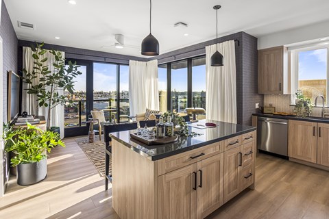 A modern kitchen with wooden cabinets and a large island.