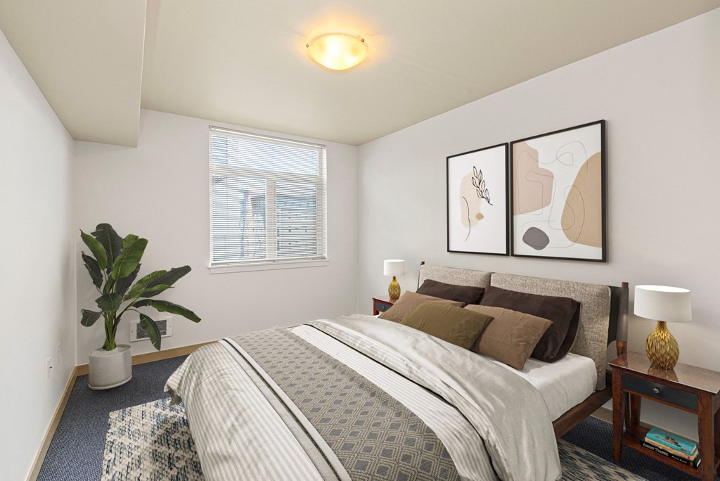 a bedroom with a bed and a potted plant