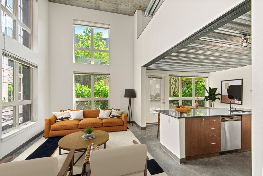 a living room with a kitchen and an open floor plan