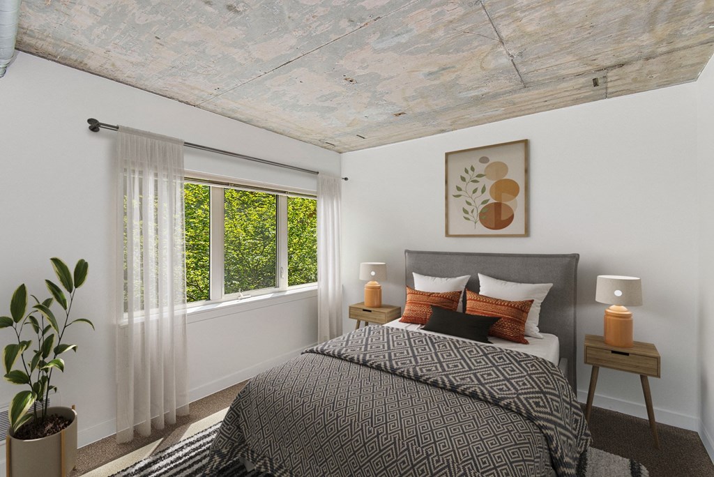 a bedroom with a bed and a large window