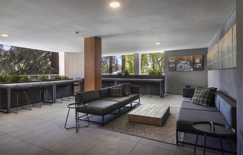 A modern living room with a grey couch and a coffee table.