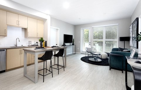 A modern kitchen with a dining table and chairs.