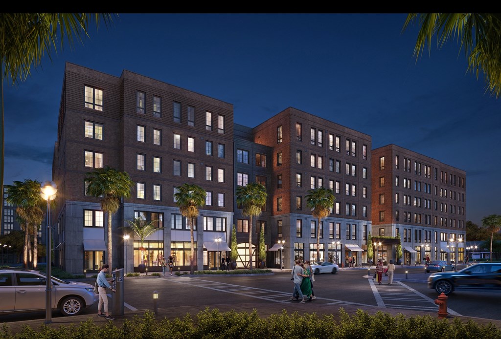 a rendering of a building at night with people walking in front of it