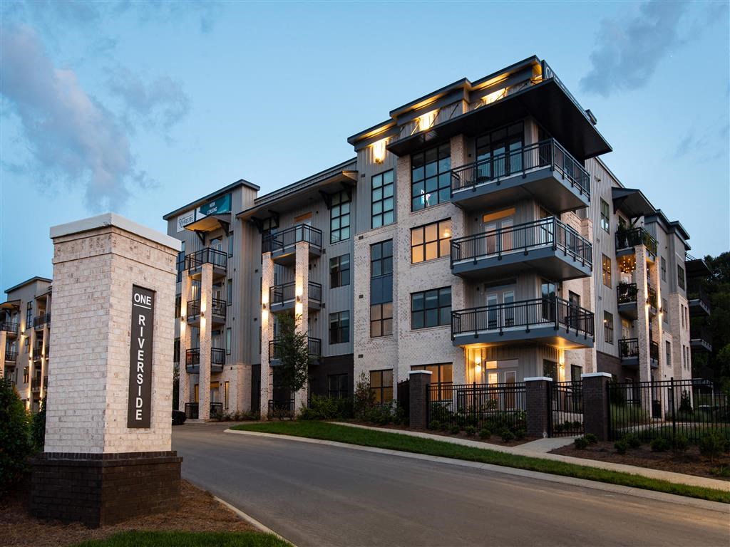 a rendering of an apartment building at dusk