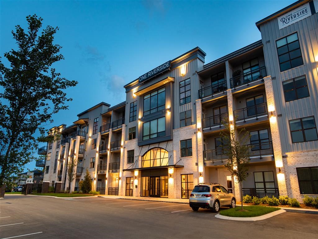 a car parked in front of an apartment building at night