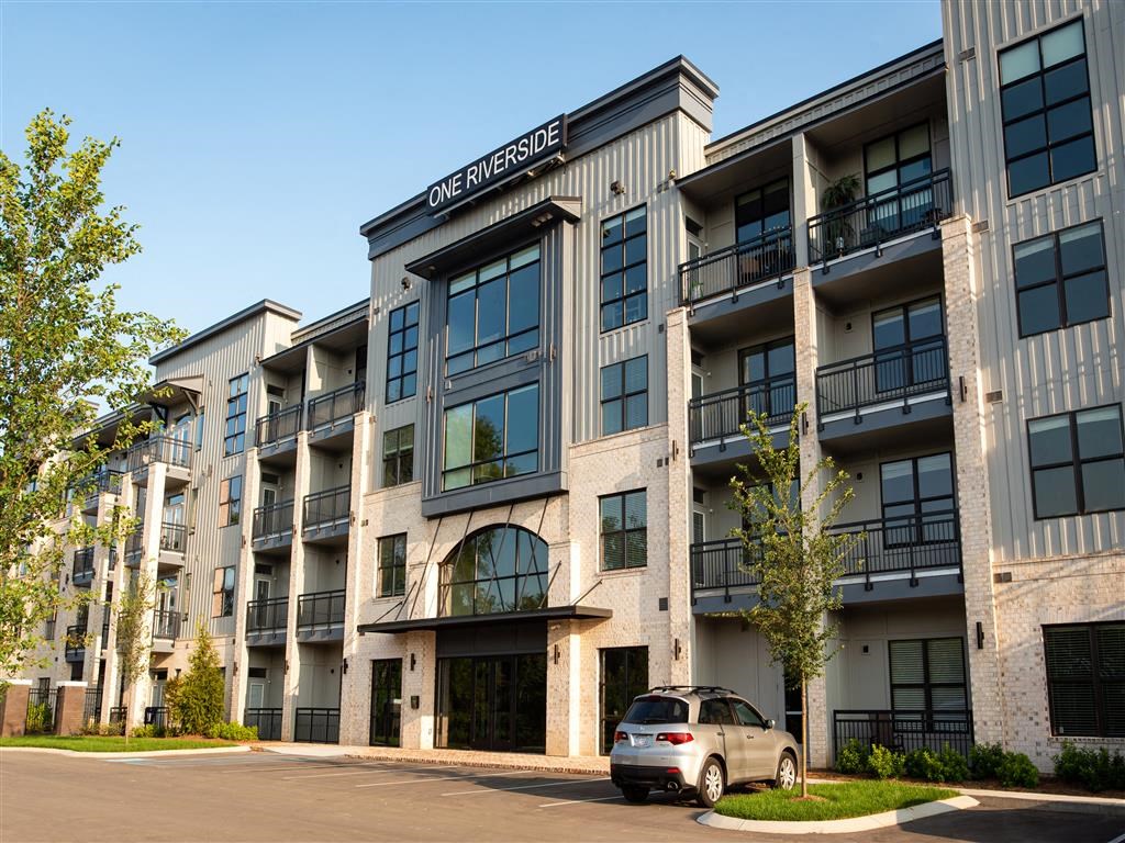 a car parked in front of an apartment building