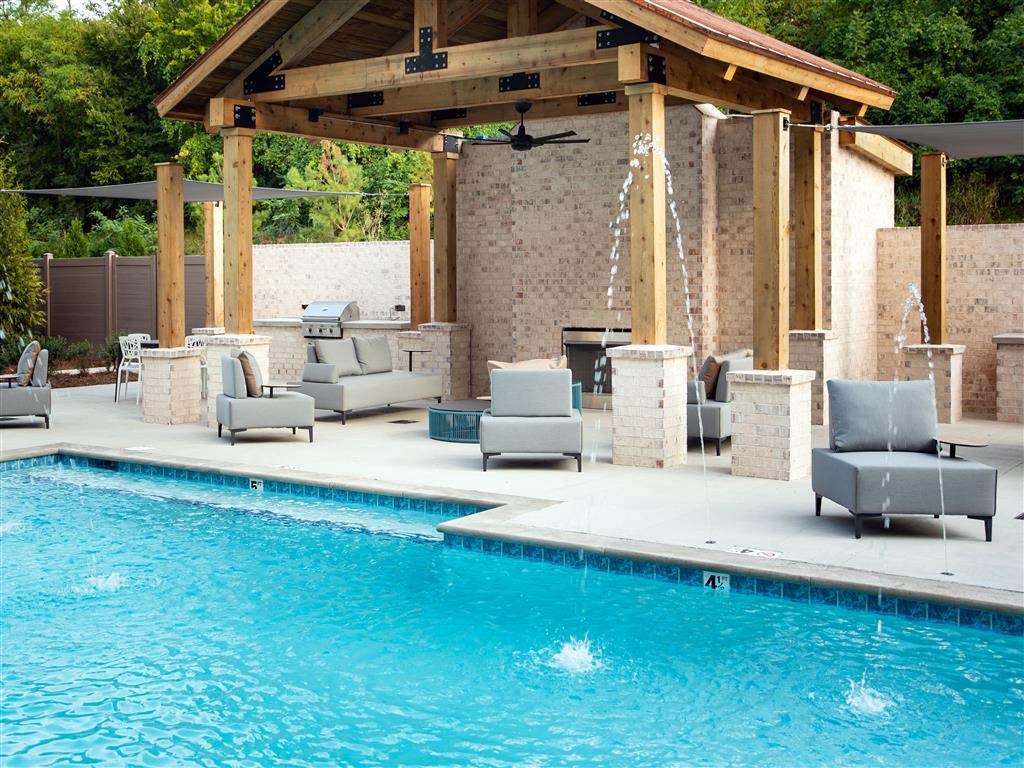 a swimming pool with patio furniture next to a pool