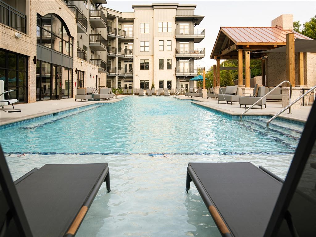 a swimming pool in front of an apartment building