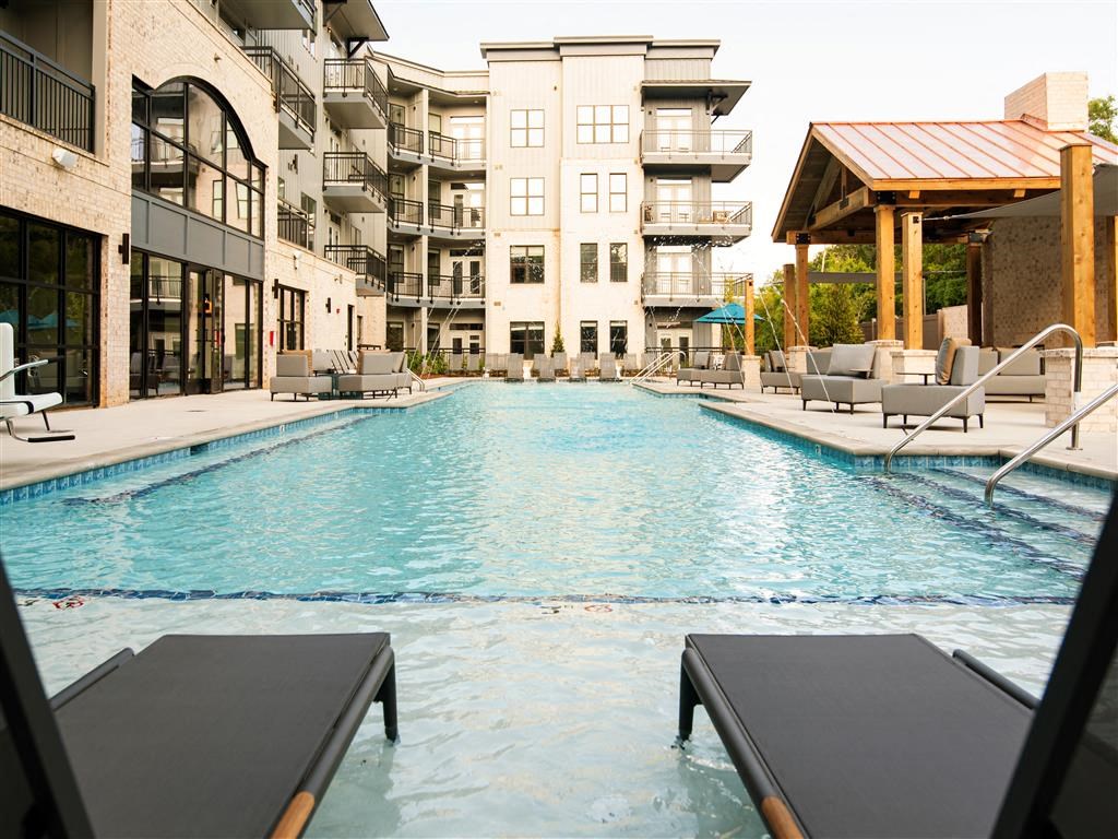 a swimming pool in front of an apartment building