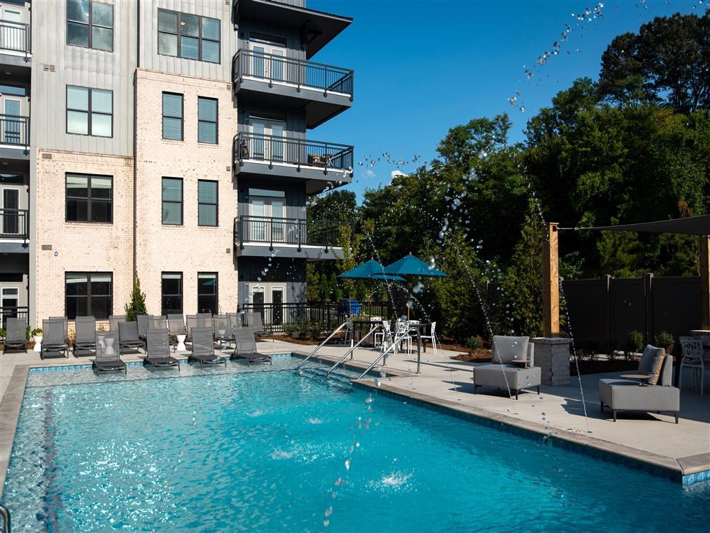 a large swimming pool in front of a building