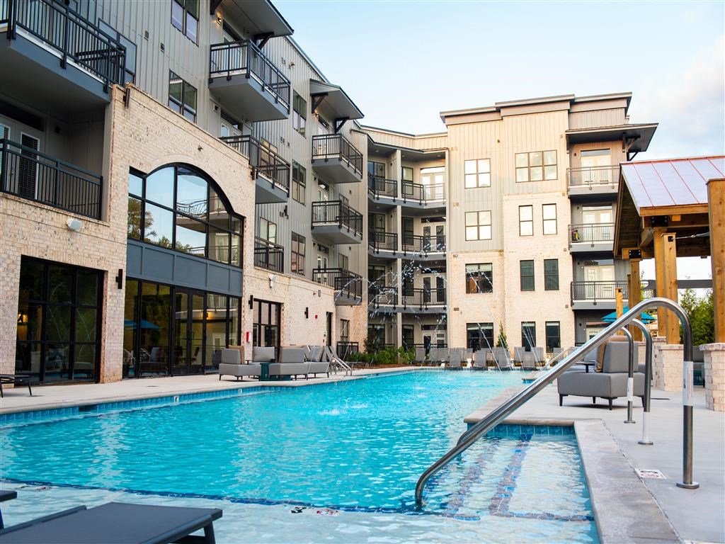 a swimming pool in front of an apartment building