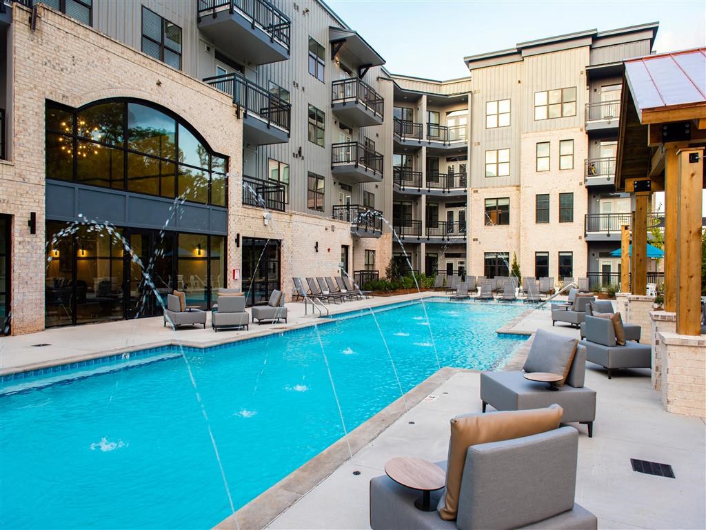 a swimming pool in front of an apartment building