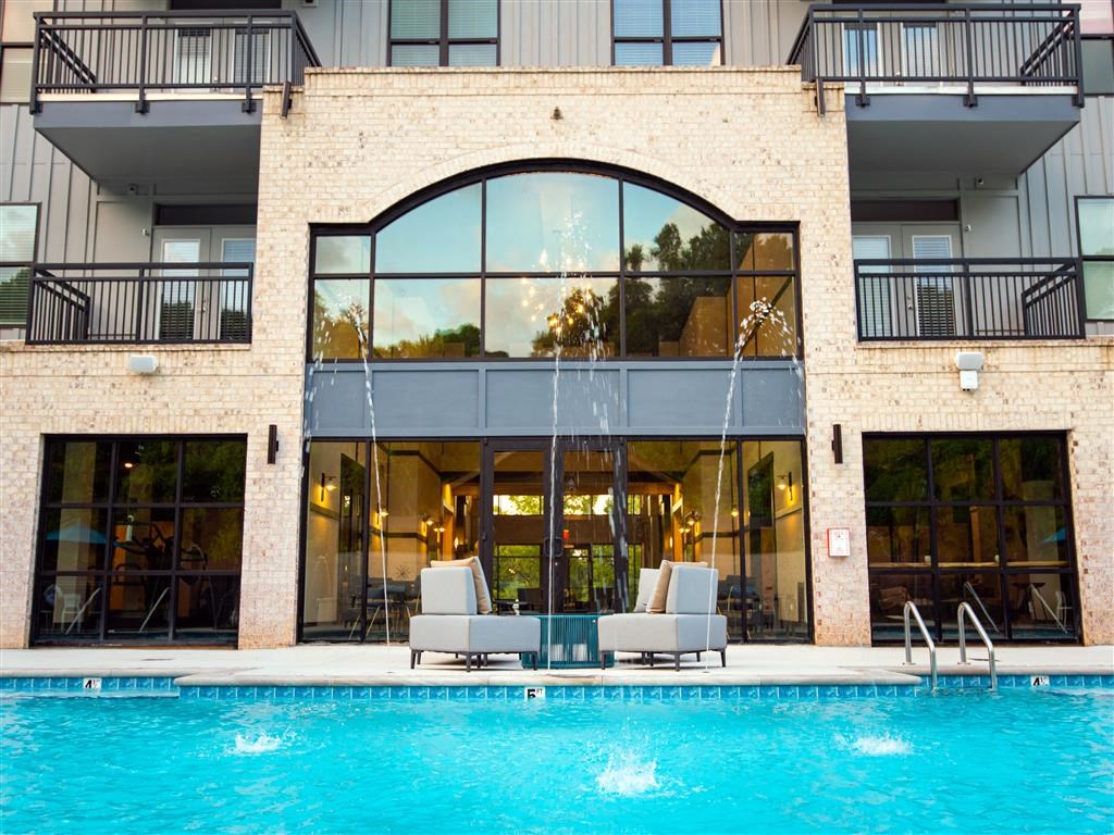 a large swimming pool in front of a building