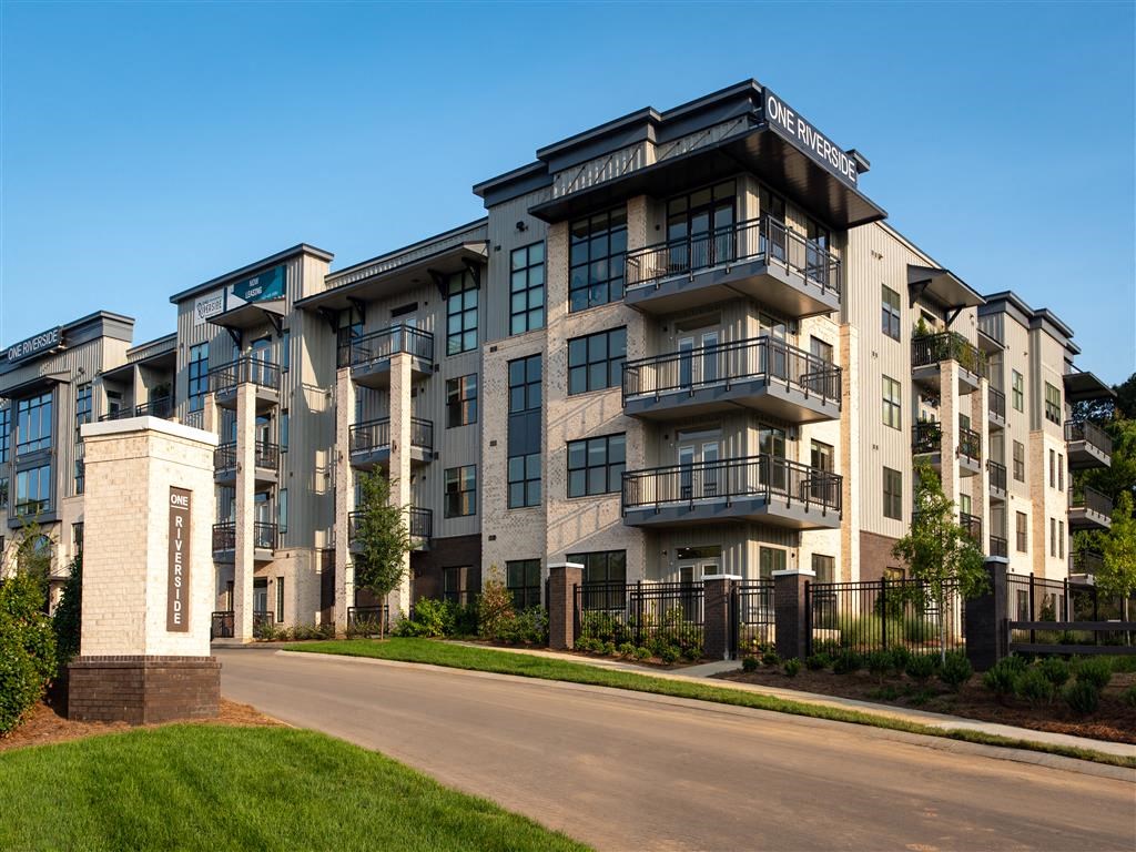 an apartment building on a street with a road