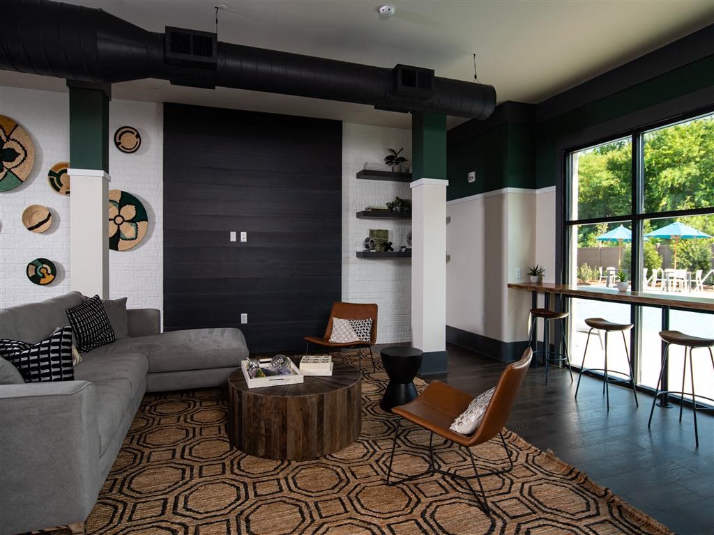 a living room with a couch and chairs and a coffee table