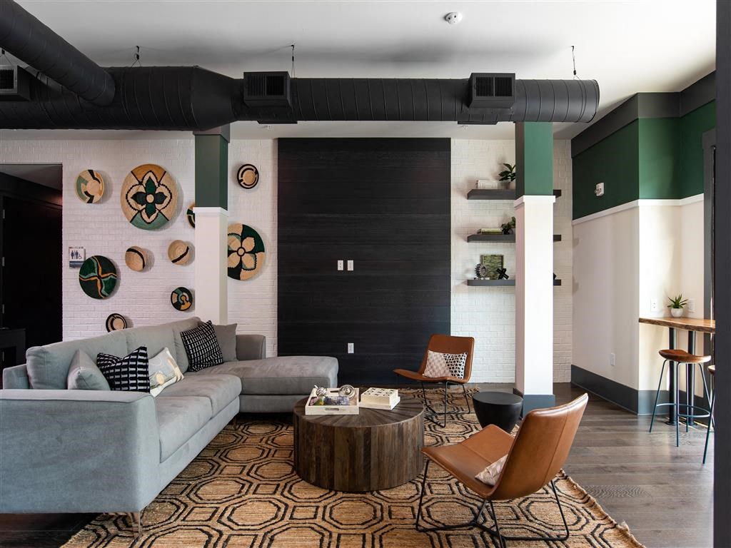 a living room with a couch and chairs and a table