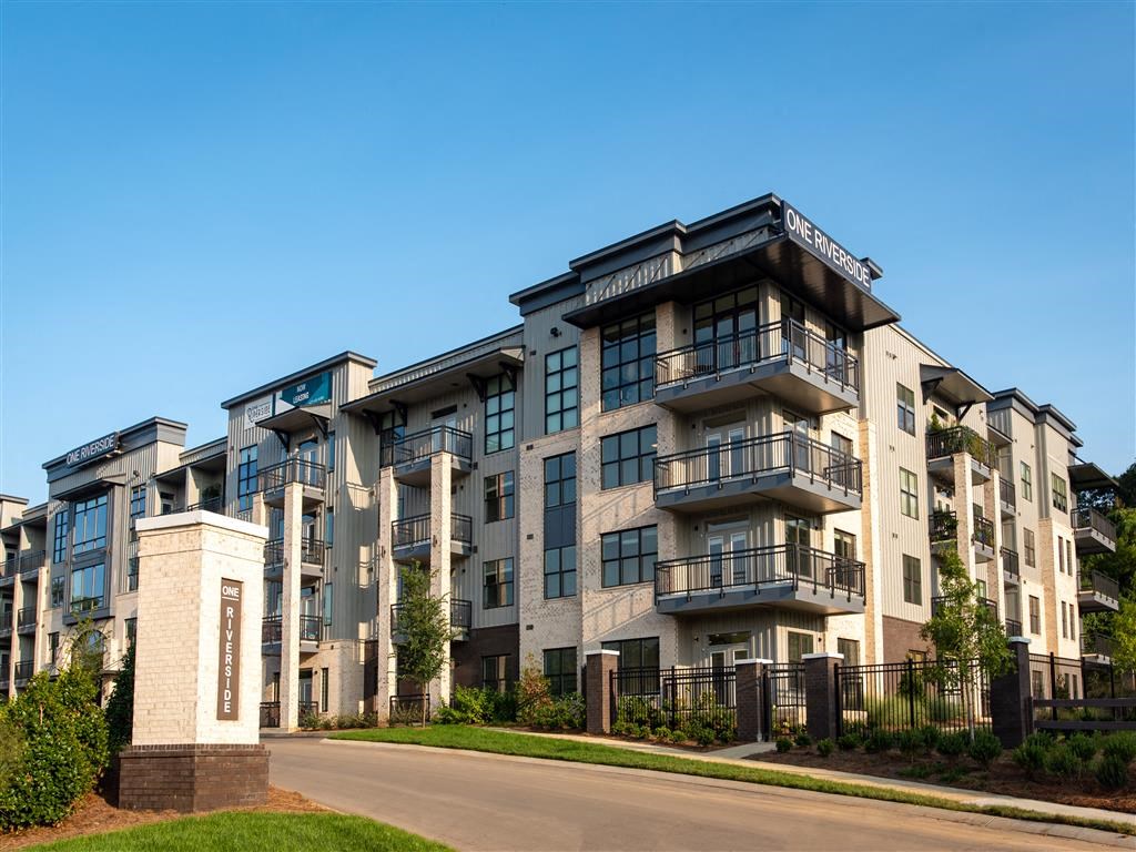 a large apartment building with balconies and a road