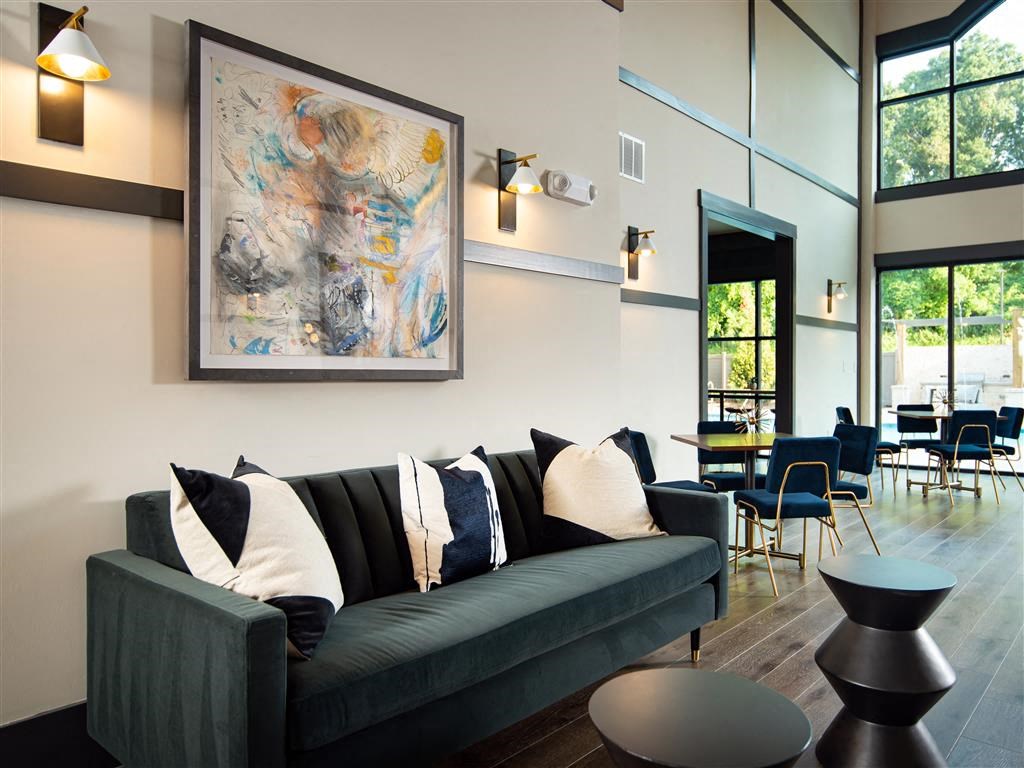 a living room with a couch and a painting on the wall