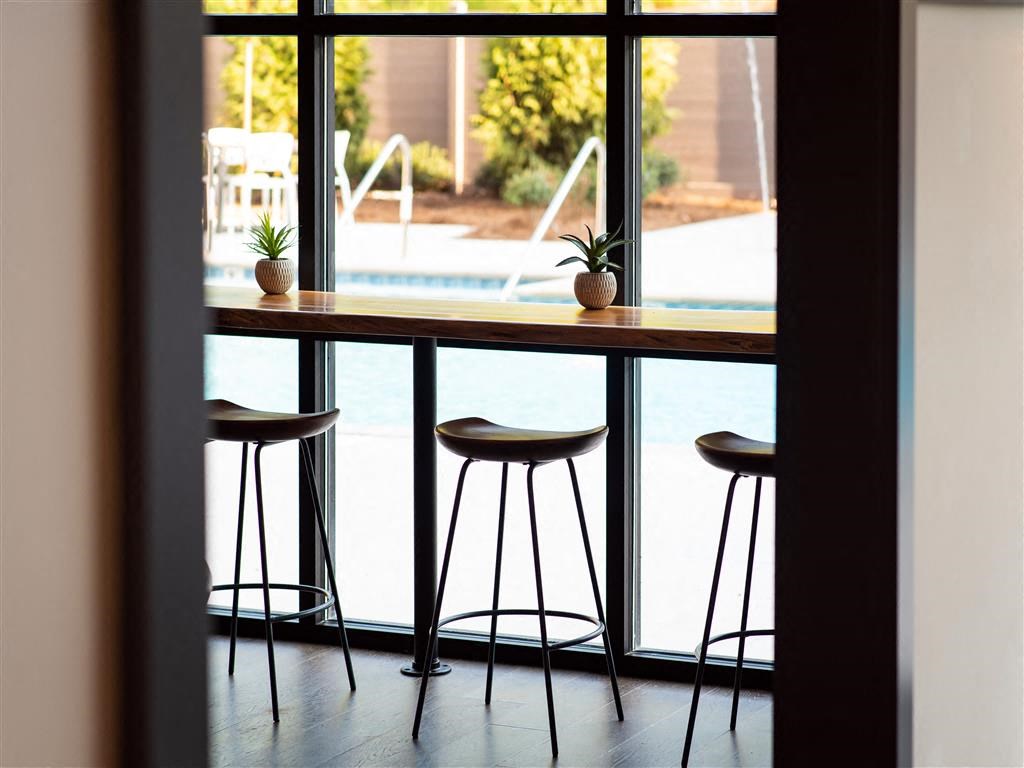 a bar with bar stools in front of a window