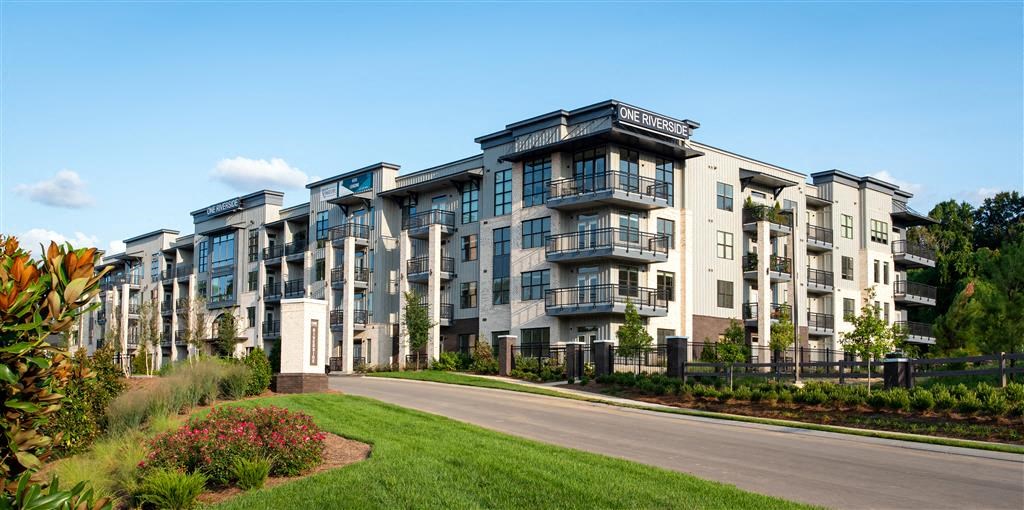 a row of apartment buildings on the side of a road