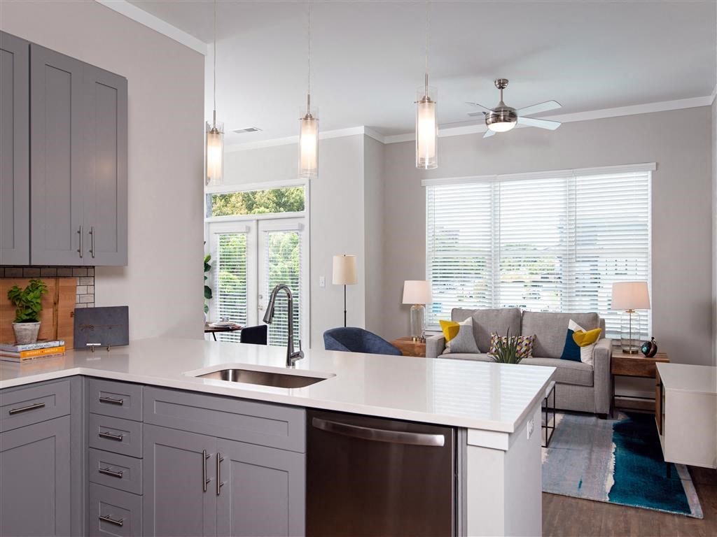 a kitchen with an island and a living room with a couch