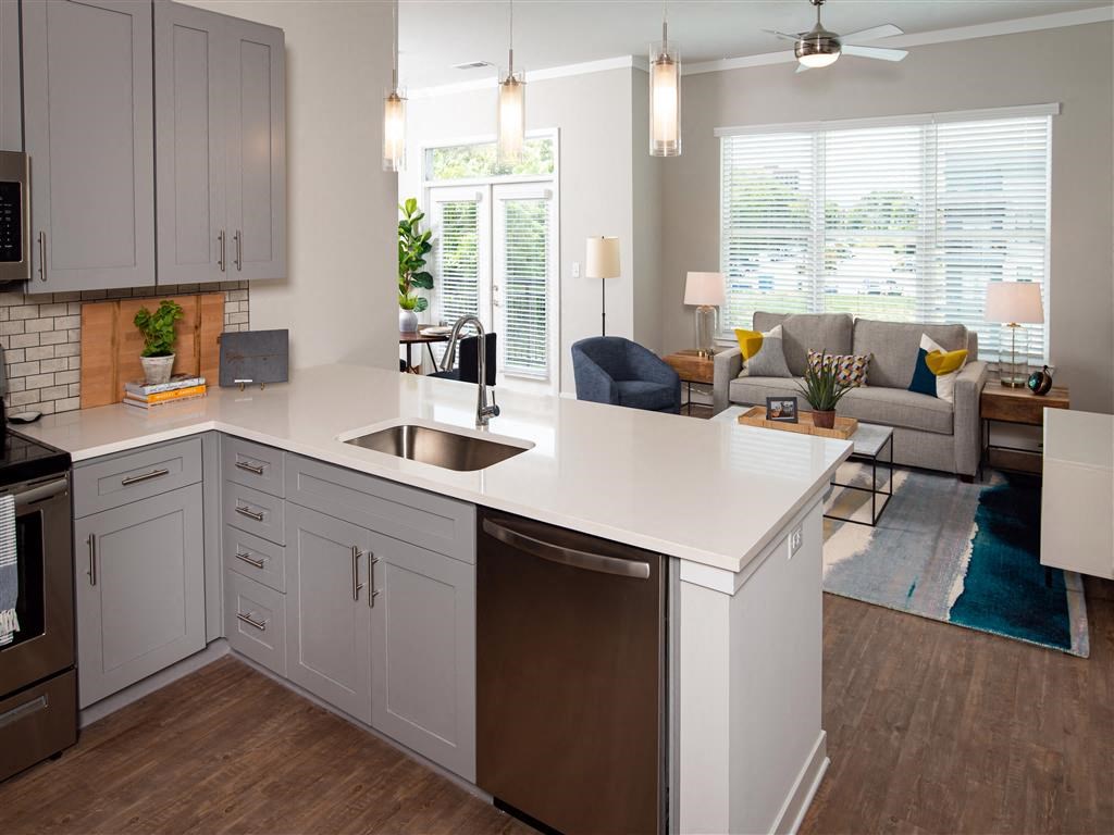 a kitchen with an island and a living room with a couch