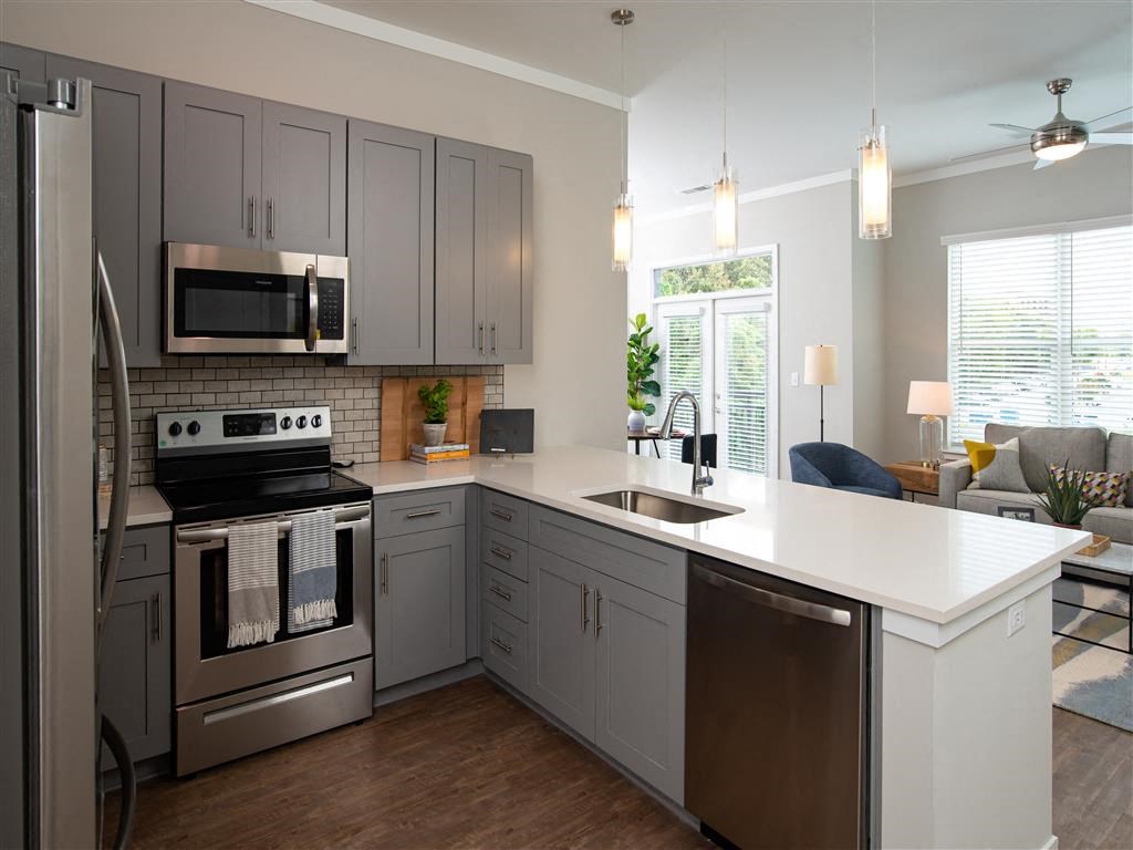 a kitchen with stainless steel appliances and a white counter top