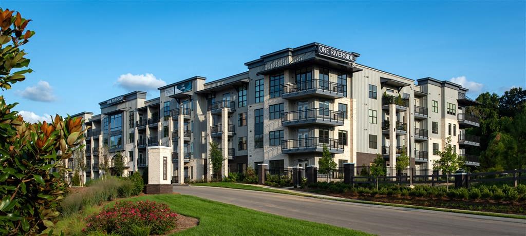 a row of apartment buildings on the side of a road