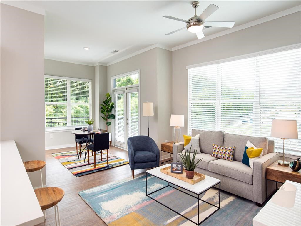 a living room with a couch and a ceiling fan