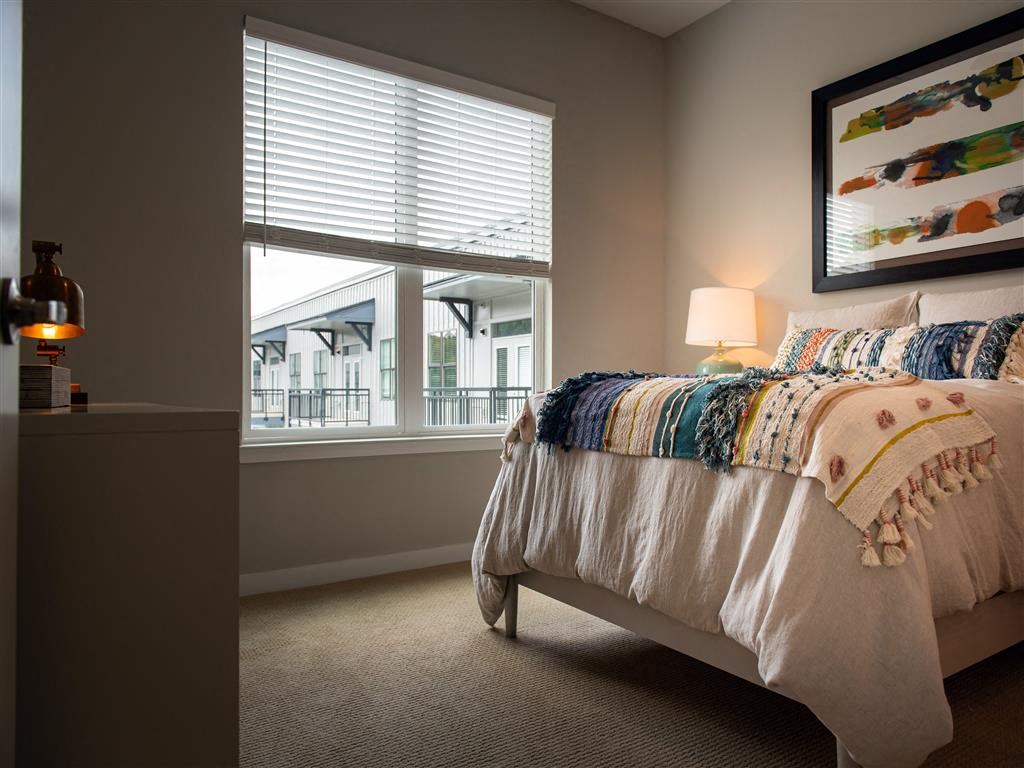 a bedroom with a bed and a window