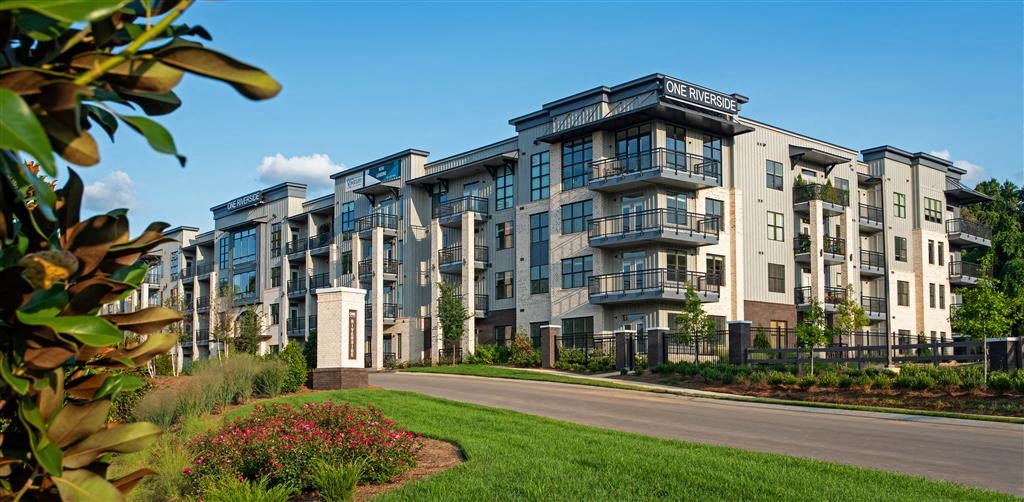 a row of apartment buildings on the side of a road