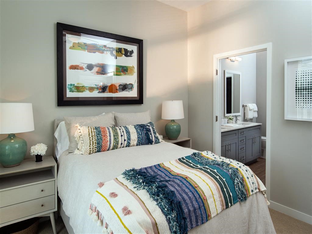 a bedroom with a bed and a mirror