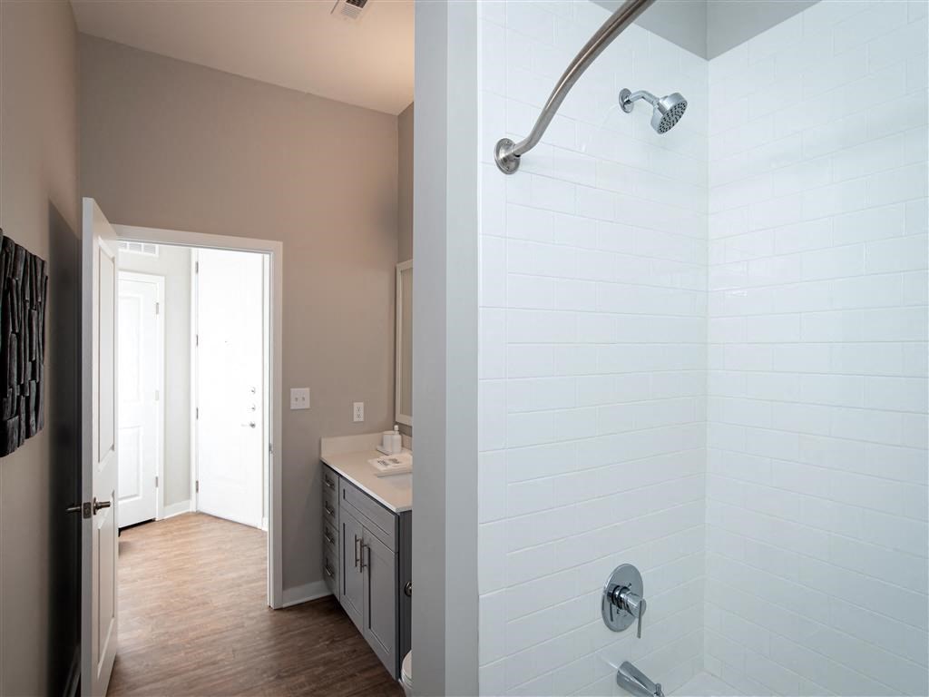 a bathroom with a shower and a sink