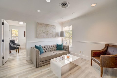 A living room with a grey couch and a coffee table.