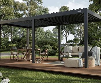 A wooden patio with a black roof and furniture.