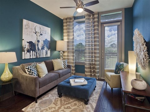 a living room with a couch and a ceiling fan
