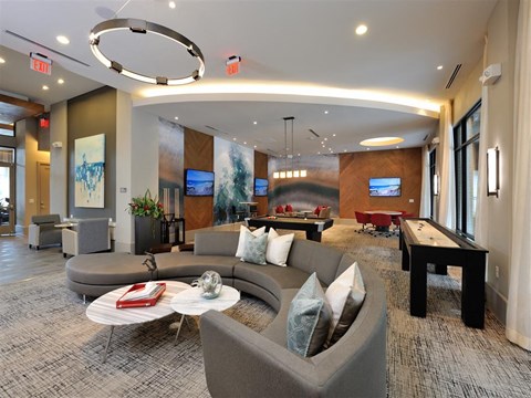 a living room with couches and a pool table