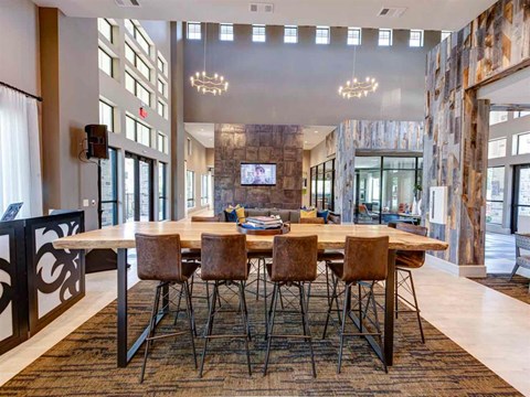 Large wooden dining table with chairs at The Pointe at Valley Ranch Town Center, New Caney
