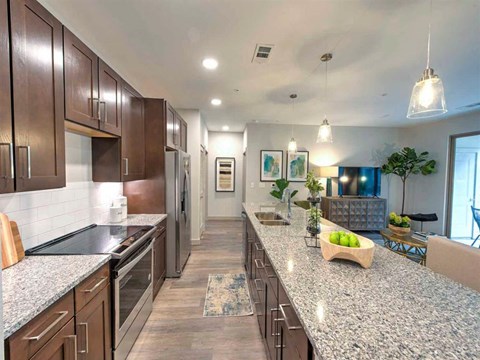 a large kitchen with granite counter tops and stainless steel appliances
