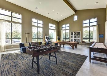 a game room with a foosball table and a pool table