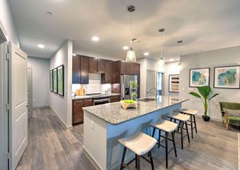 a kitchen with a large island with stools