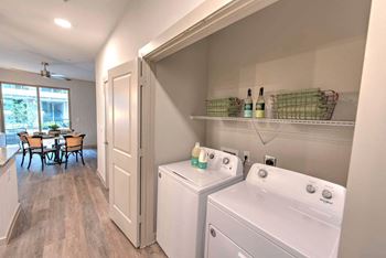 a washer and dryer in a laundry room next to a dining room table