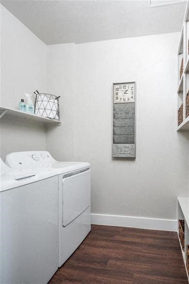 a white laundry room with a clock on the wall