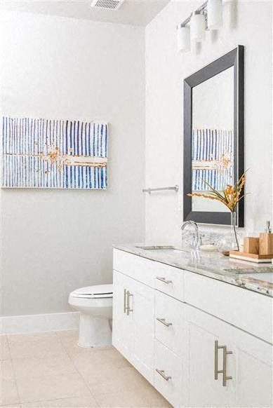 a white bathroom with a white toilet and a mirror