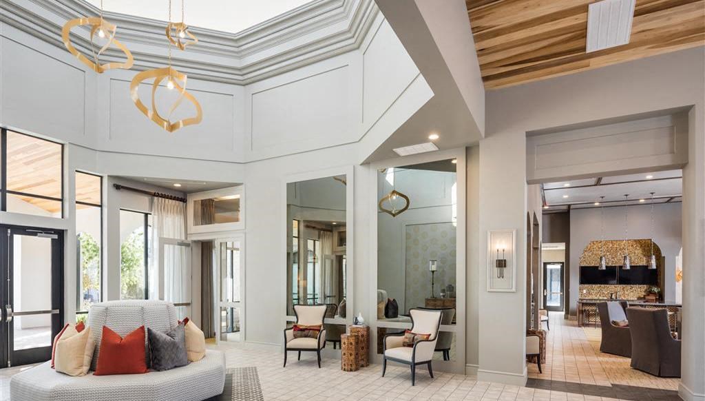 a large living room with a couch and chairs