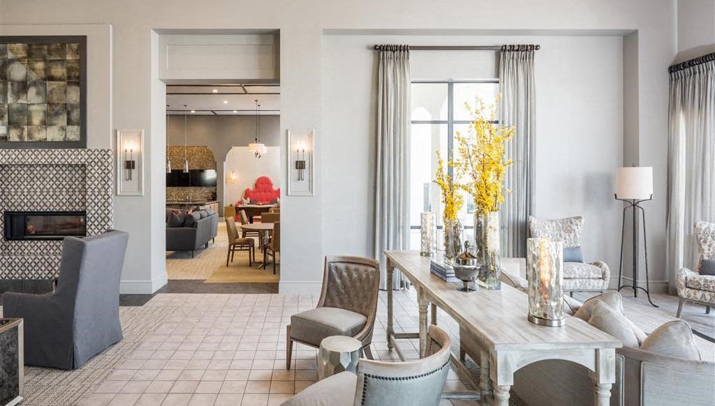 a living room filled with furniture and a table