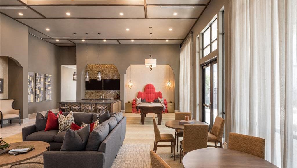 a living room with couches and chairs and a table