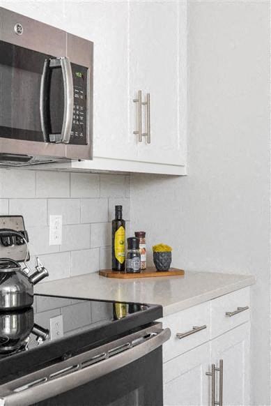 a kitchen with a stove and a microwave